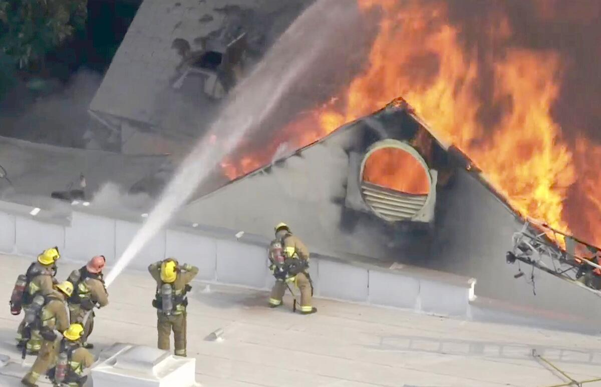 Firefighters put out a fire at the former Hollywood Playhouse Theater