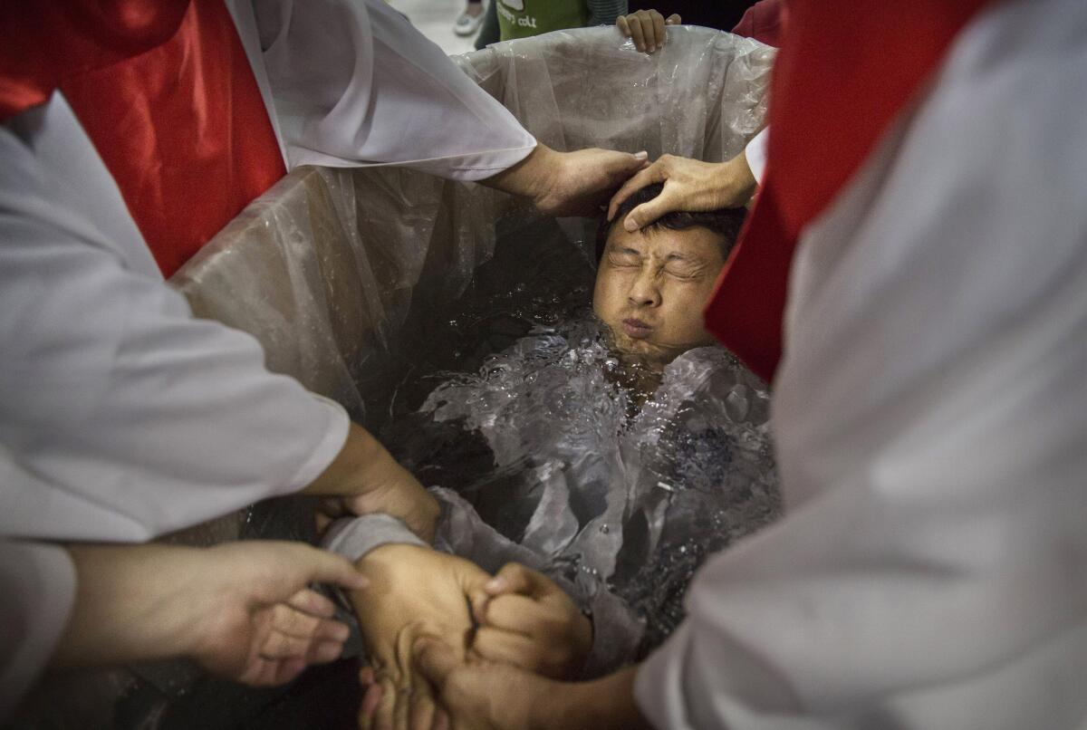 A man is baptized in Beijing.