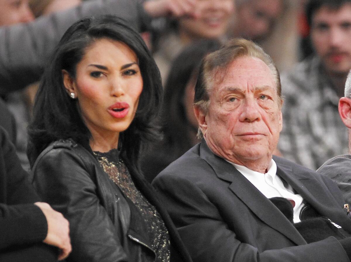 Donald Sterling and V. Stiviano watch the Clippers play.