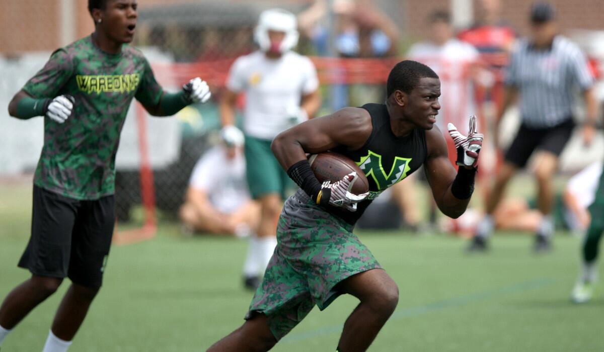 Narbonne defender Lawson Hall returns an interception during a passing tournament.