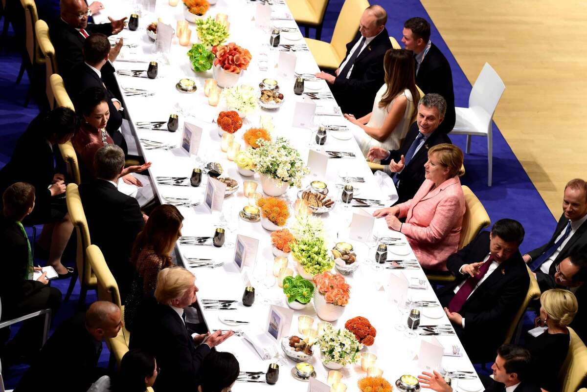 World leaders including President Trump, lower left, and Vladimir Putin, upper right, attend a banquet at the G-20 Summit in Hamburg, Germany, on July 7, 2017.