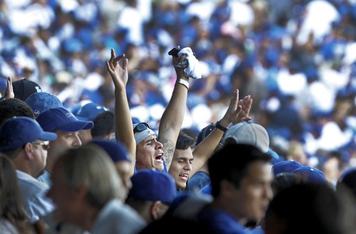 Dodgers fans cheer after the final out in a 6-4 victory over the St. Louis Cardinals in Game 5 of the NLCS.