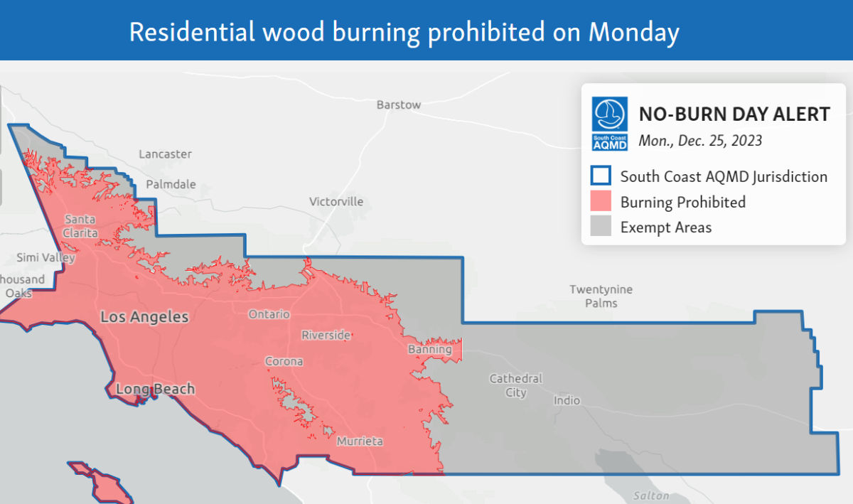 A map of Southern California shows a large swath of pink, indicating where wood burning is prohibited on Christmas Day.