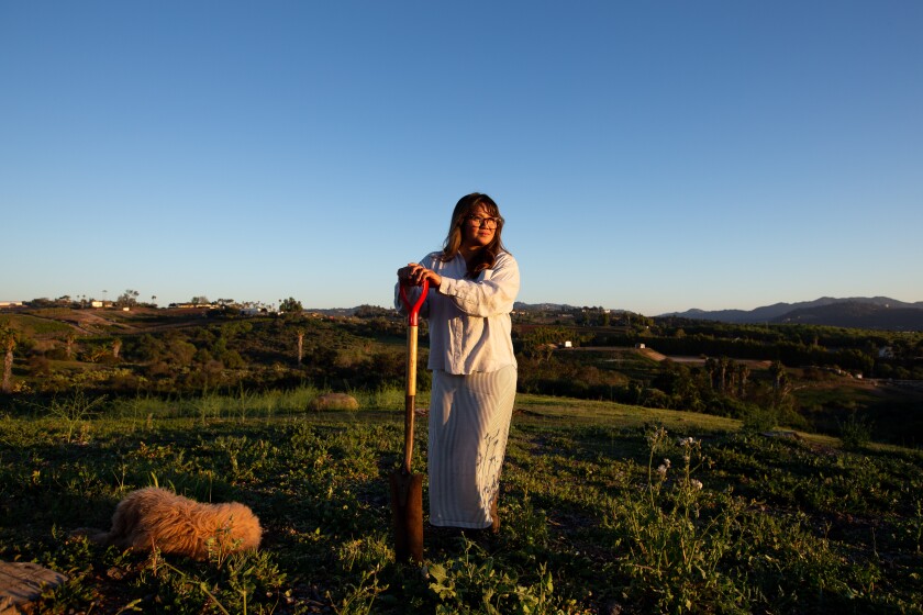 Chef Lan Thai, 44, at her newly purchased 19-acre Enclave Farm in Bonsall with her goldendoodle Ziggy.