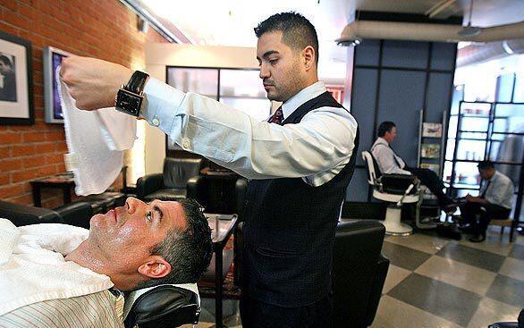Barber Cesar Paniagua applies a hot towel to customer Henry Vitale's face in order to soften the beard before a shave on Jan. 6, 2010 at the Shave of Beverly Hills.