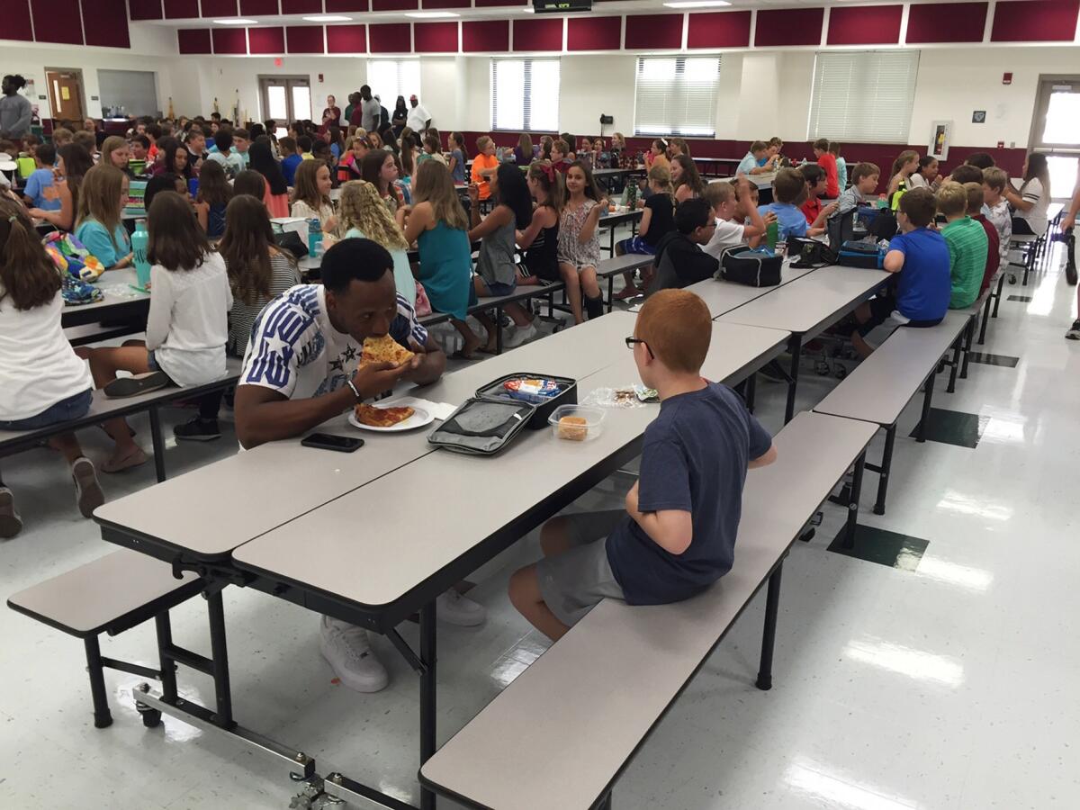 Florida State University wide receiver Travis Rudolph has lunch with Bo Paske at Montford Middle School in Tallahassee, Fla. on Tuesday, Aug. 30, 2016. A small gesture of kindness by Rudolph sent tears streaming down the face of the sixth-grader's mother, Leah Paske, who shared her gratitude on Facebook after seeing a picture of Rudolph sharing lunch with her son Bo in his middle school cafeteria.