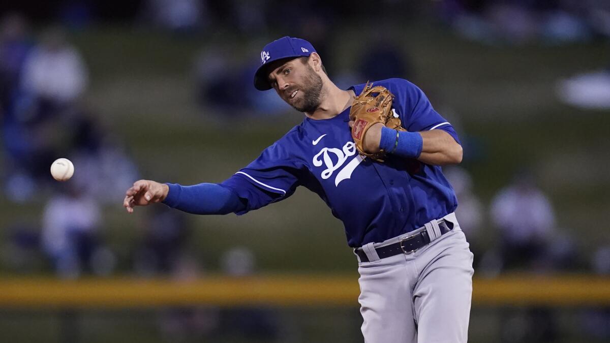 Dodgers second baseman Chris Taylor throws to first during a spring training baseball game.