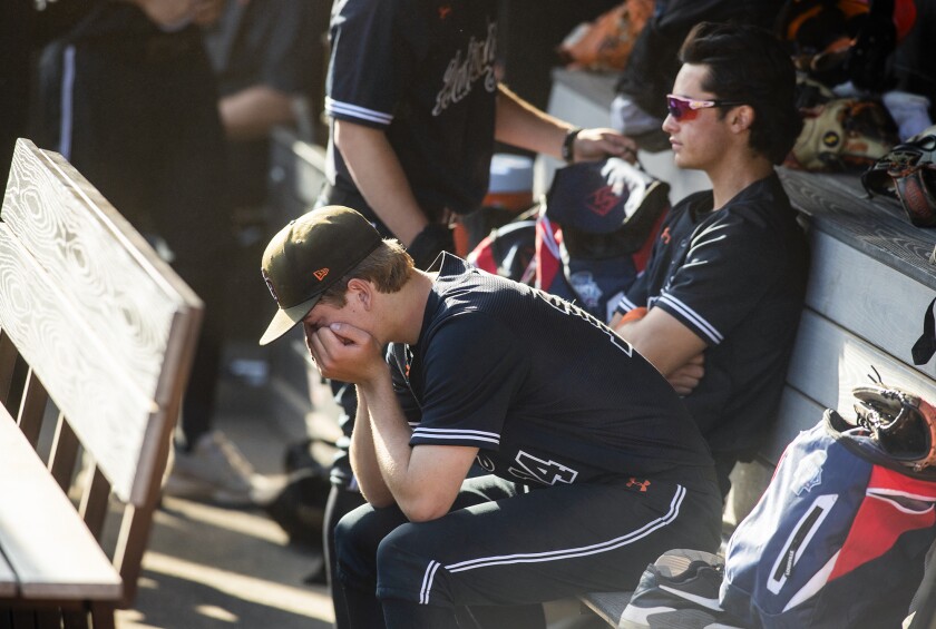Huntington Beach starting pitcher Ben Jacobs sits in the dugout after the Oilers lost to Sherman Oaks Notre Dame on Tuesday.