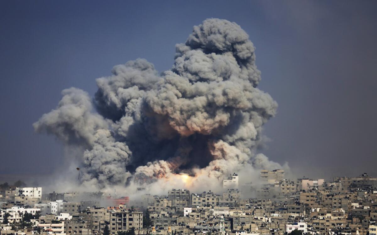 In this July 2014 file photo, smoke and fire from an Israeli strike rise over Gaza City.