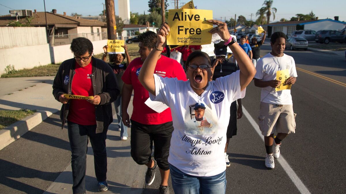 Sandra Hall of San Bernardino marches with about 200 community members in a Peace Walk to honor the victims of homicides and call for an end to gun violence on May 19, 2016, in San Bernardino. (Gina Ferazzi / Los Angeles Times)