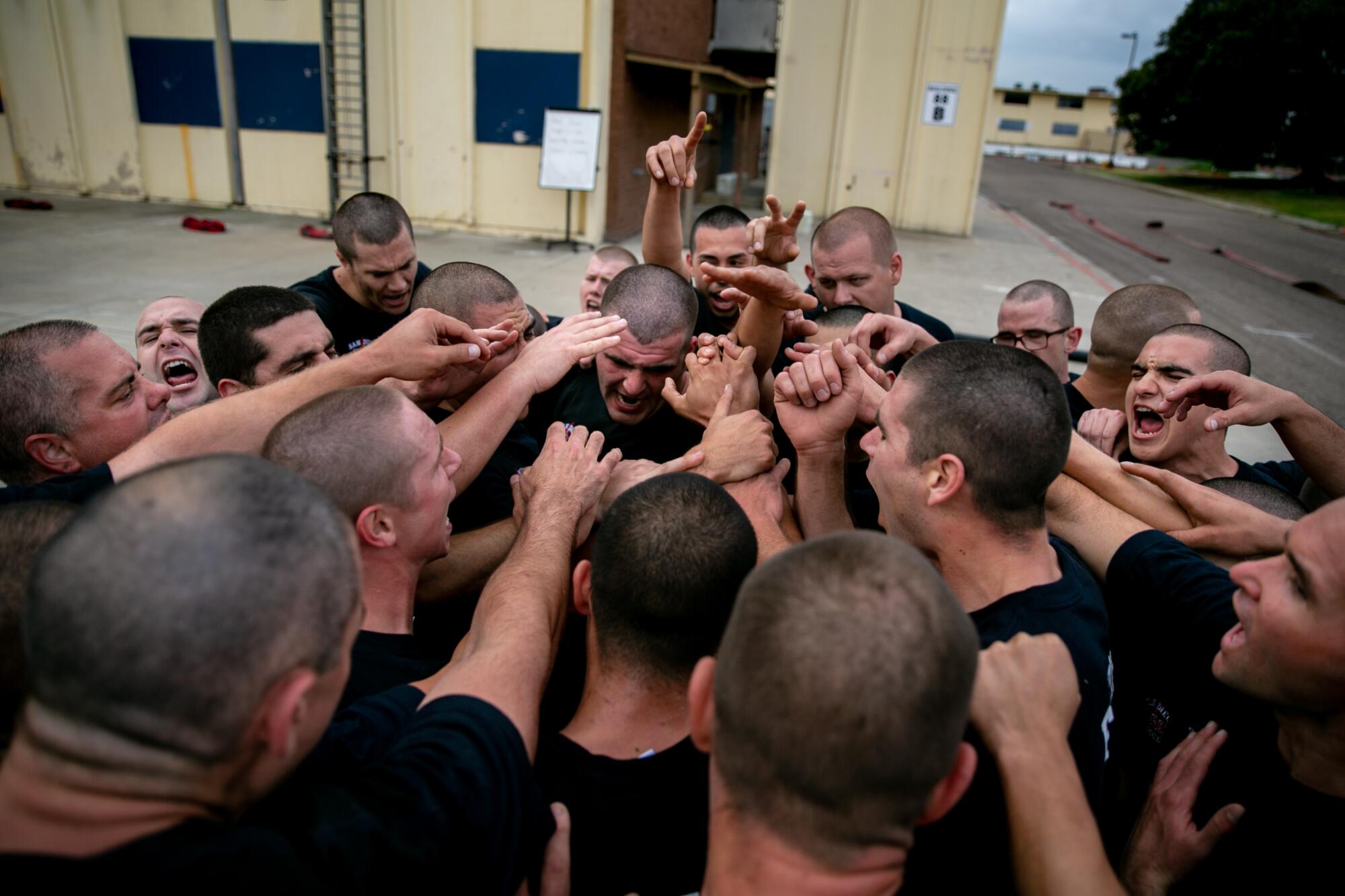 Recruits huddle together and chant "87! 87! 87!" after completing their morning exercise. Their instructor pointed out that they'd left one of their fellow recruits behind.