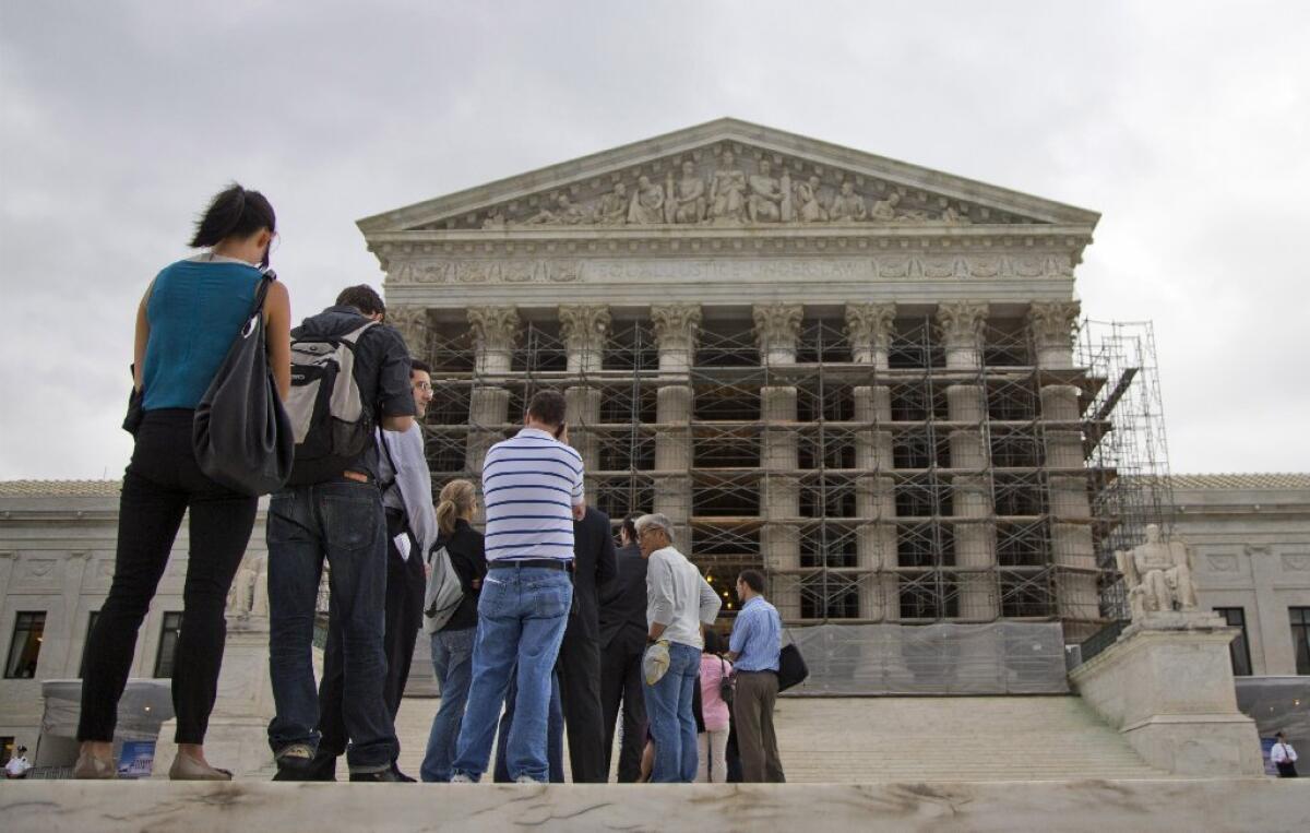 The U.S. Supreme Court will hear oral arguments Tuesday in a case weighing the constitutionality of an Ohio law criminalizing false political speech. Above, people are seen waiting outside the Supreme Court building in Washington last October.