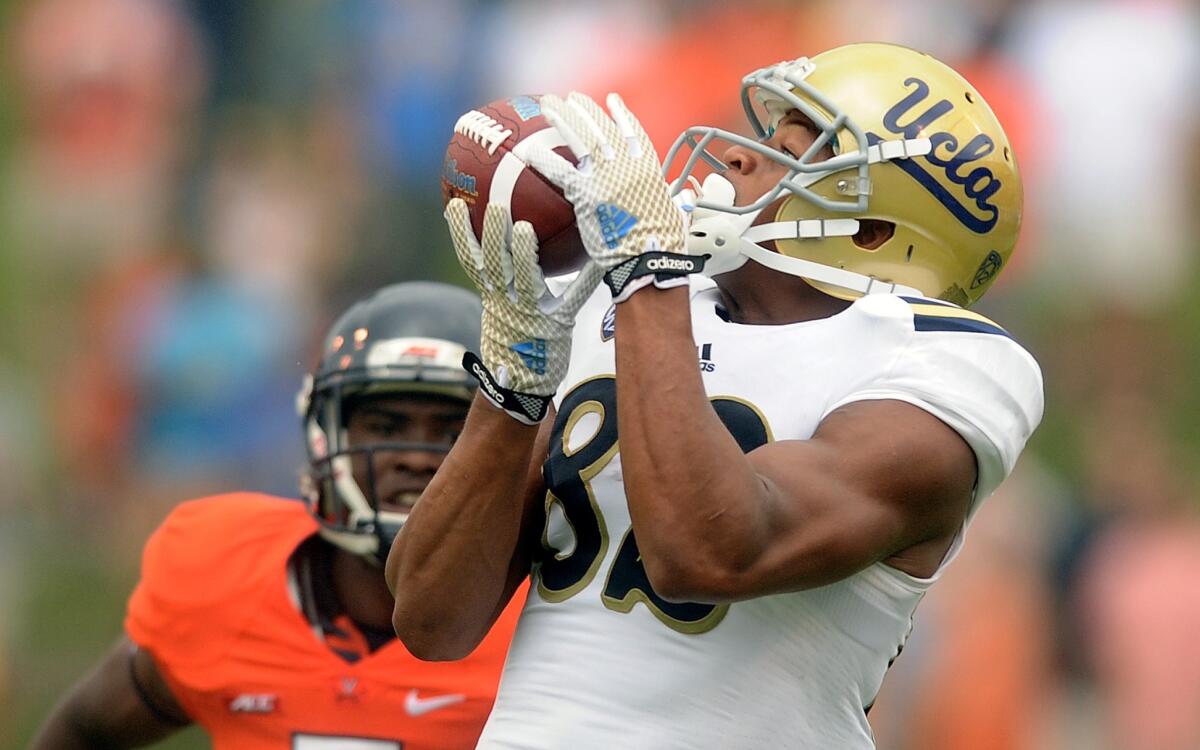UCLA receiver Eldridge Massington catches a long pass against Virginia during the first quarter of a game on Aug. 30. Massington lost his freshman season in 2013 to a torn ligament in his left knee.