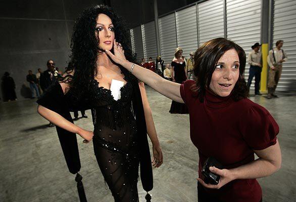 Aileen Stein checks out a wax figure of Cher, which is among more than 200 hand-sculpted statues that will be sold by the Hollywood Wax Museum as it modernizes. The life-size replicas made of oil-painted wax are at a Newbury Park warehouse.