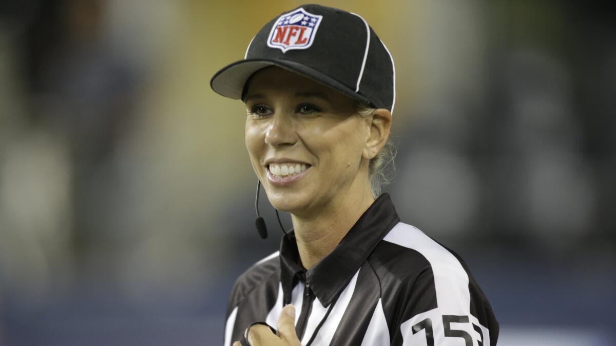 Sarah Thomas smiles as she officiates during a preseason game between the Seattle Seahawks and San Diego Chargers in Seattle on Aug. 15, 2014.