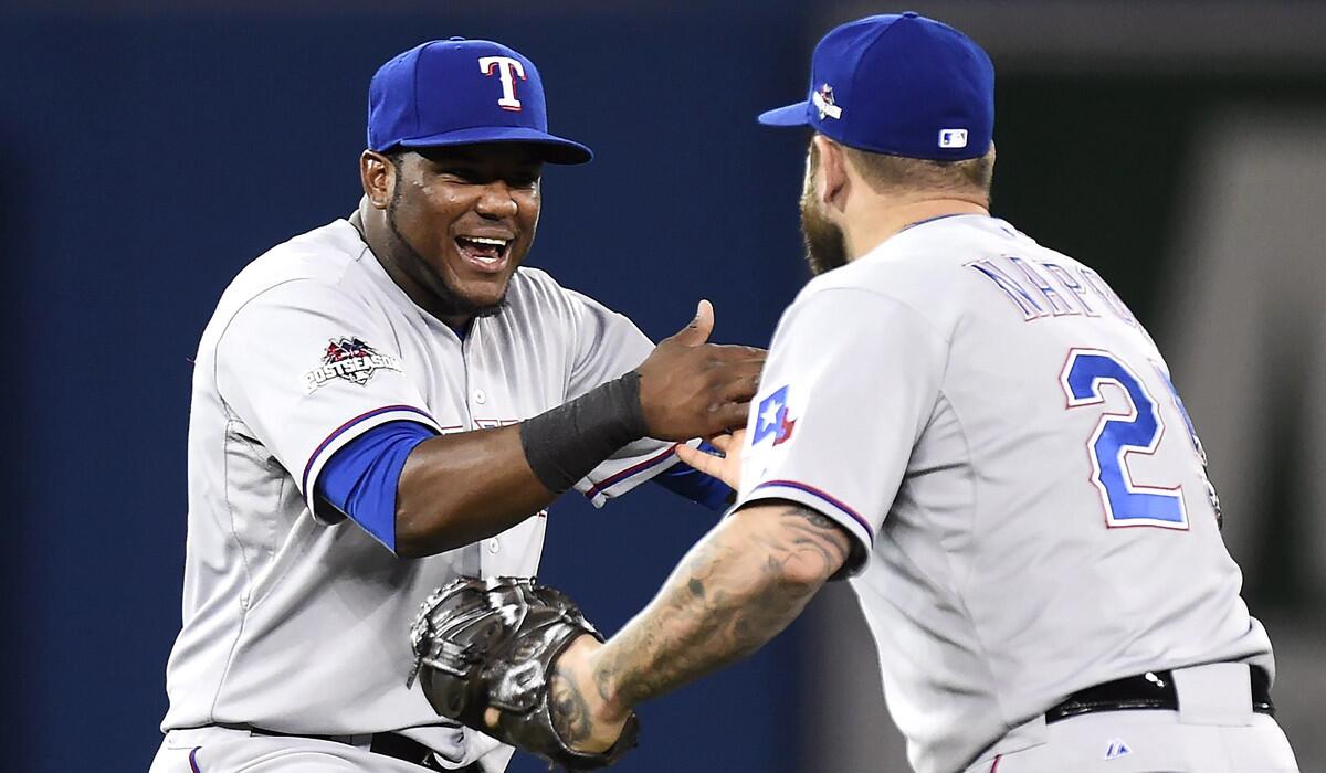 Texas Rangers' Hanser Alberto, left, celebrates with teammate Mike Napoli following their win over the Toronto Blue Jays after the 14th inning on Friday.