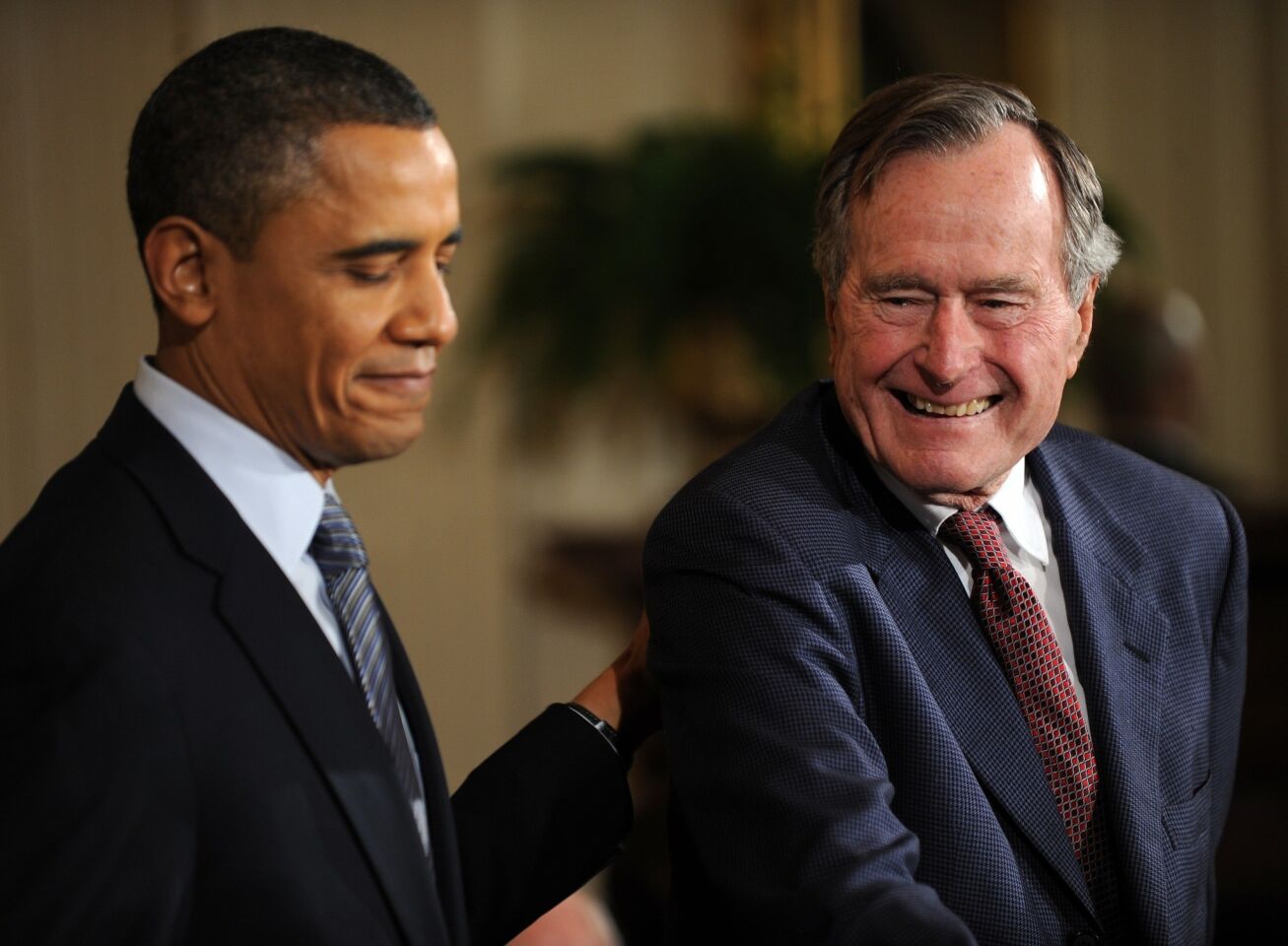 President Obama presents the Medal of Freedom to former President George H.W. Bush at the White House in 2011.