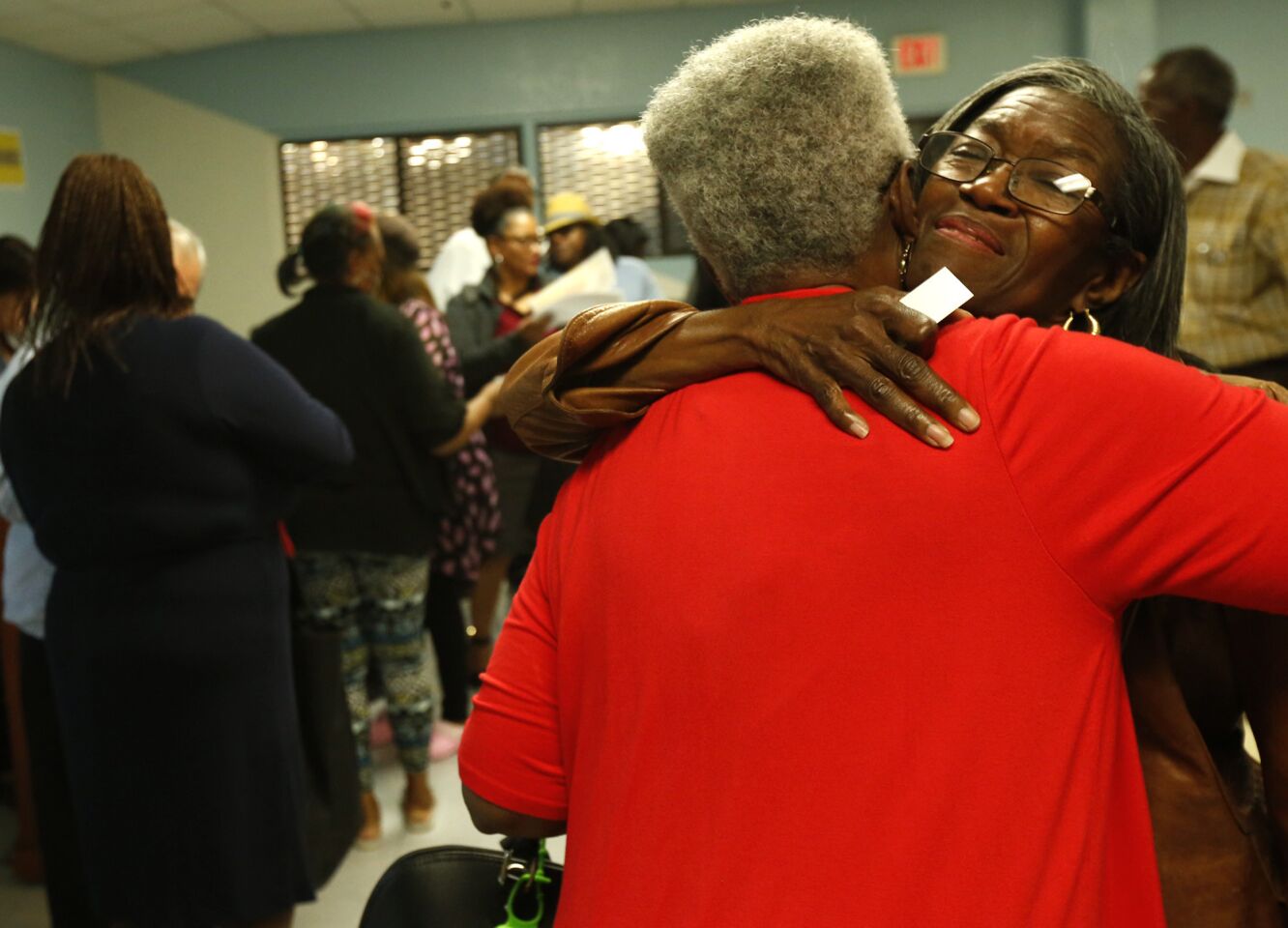 Compton City Council member Emma Sharif, right, hugs Earlene Diggs, 80, at the end of a rally to "Stop the Violence" in Compton. Diggs' son and grandson were killed in gang-related shootings in the city.