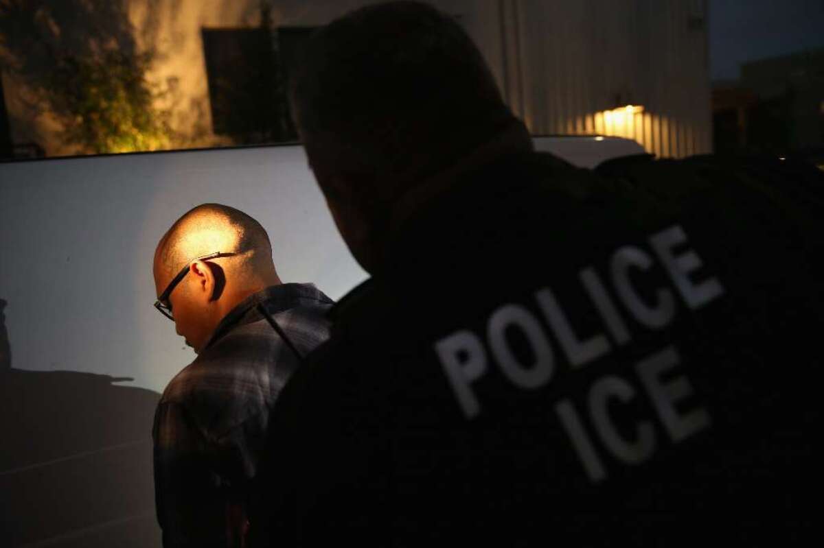 A man is detained by Immigration and Customs Enforcement (ICE), agents early on October 14, 2015 in Los Angeles, California. ICE agents said the undocumented immigrant was a convicted criminal and gang member who had previously been deported to Mexico and would be again.