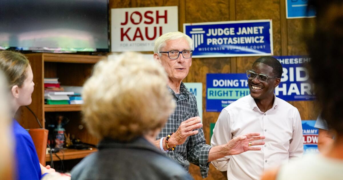 Photo: latimes.com Wisconsin Gov. Tony Evers, center left, speaks in support of David Crowley, right, Democratic candidate for Wisconsin