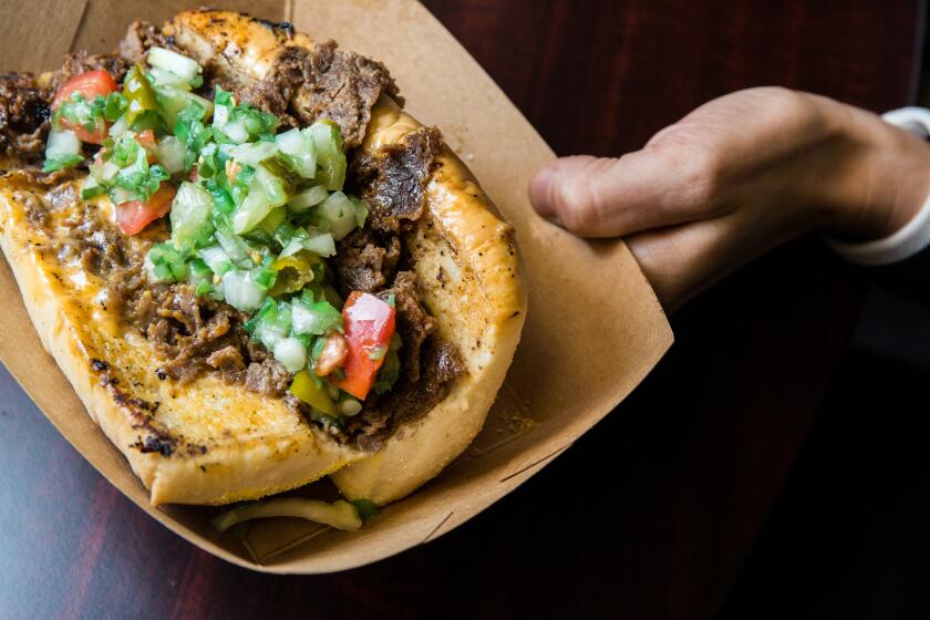 Merkt's Cheesy Beef Sandwich, a thinly-sliced ribeye steak grilled and tossed with Merkt's cheese, then served on a hoagie roll and topped with Chi-Town Pico.