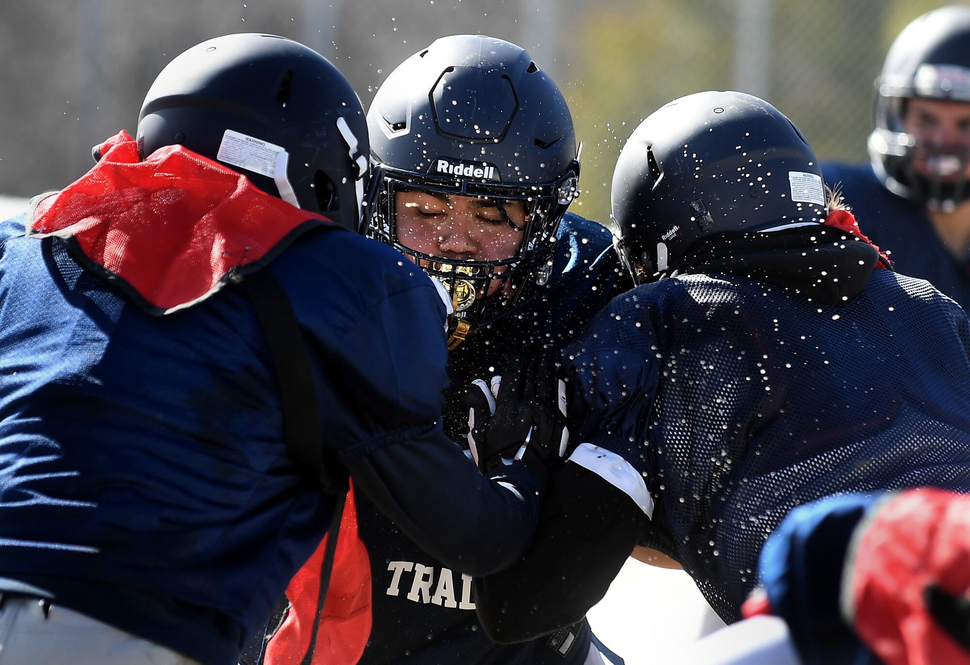 Isaiah Torres, center and other Rim of the World High School football players practice in the snow