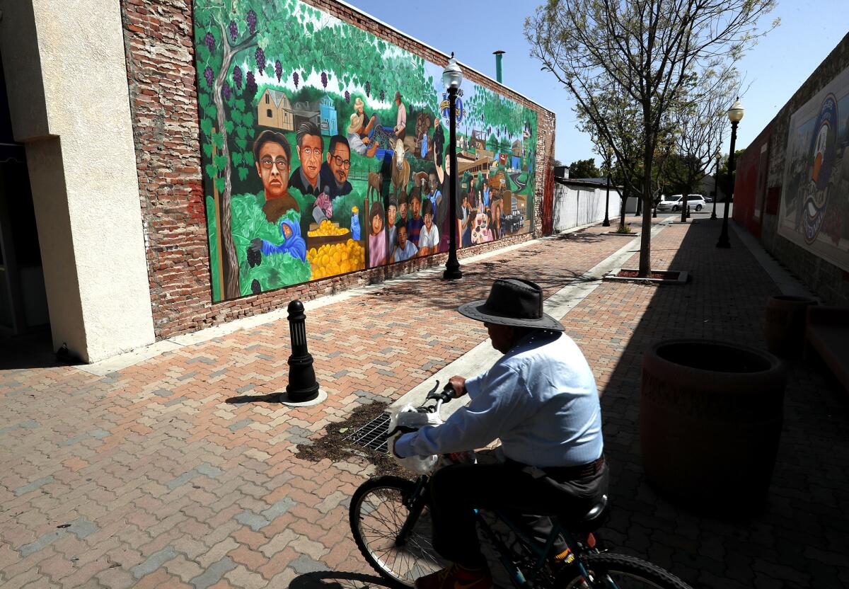 A mural celebrating the 100th anniversary of Delano lies on Main Street. The city's population is a little more than 52,000 people, about 76% Latino and nearly 40% foreign born.