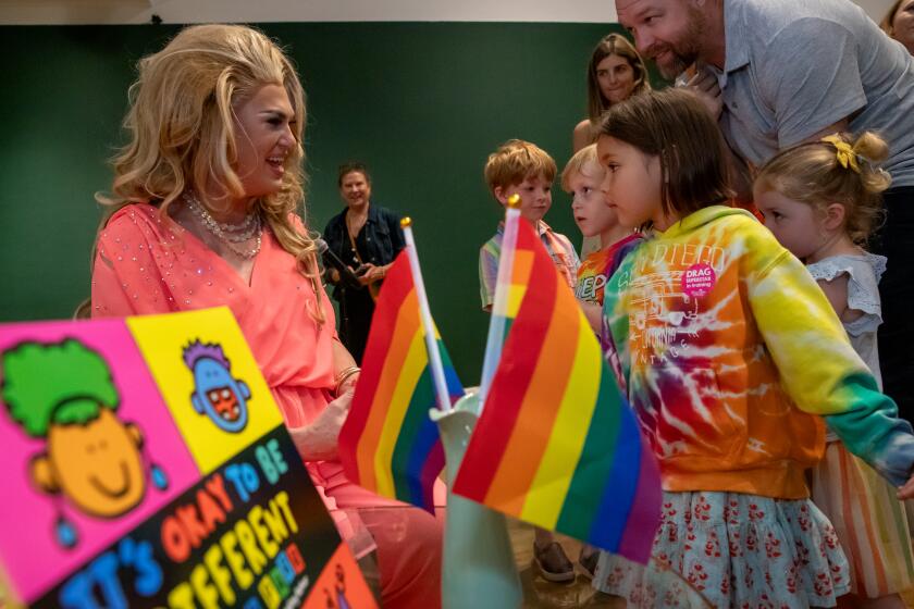 LAGUNA BEACH, CA - JUNE 17: Drag Queen Pickle, left, reads a story to children during Drag Queen Story Hour at Laguna Art Museum, Laguna Beach, CA. (Irfan Khan / Los Angeles Times)