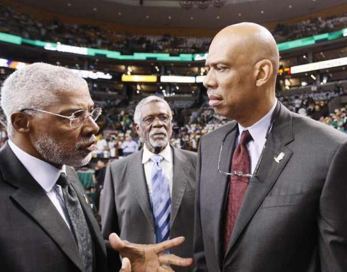 Julius Erving, left, might be a fan of Bill Russell, center, and Kareem Abdul-Jabbar, but he doesn't trust their old teams, the Celtics and the Lakers.