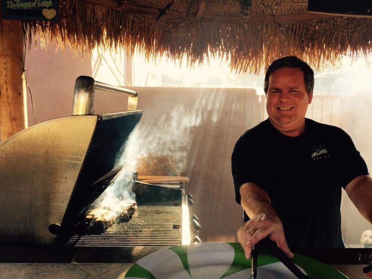 Tim Zook grills steaks for his family. Zook, a healthcare worker, died after receiving his second dose of a COVID vaccine. 