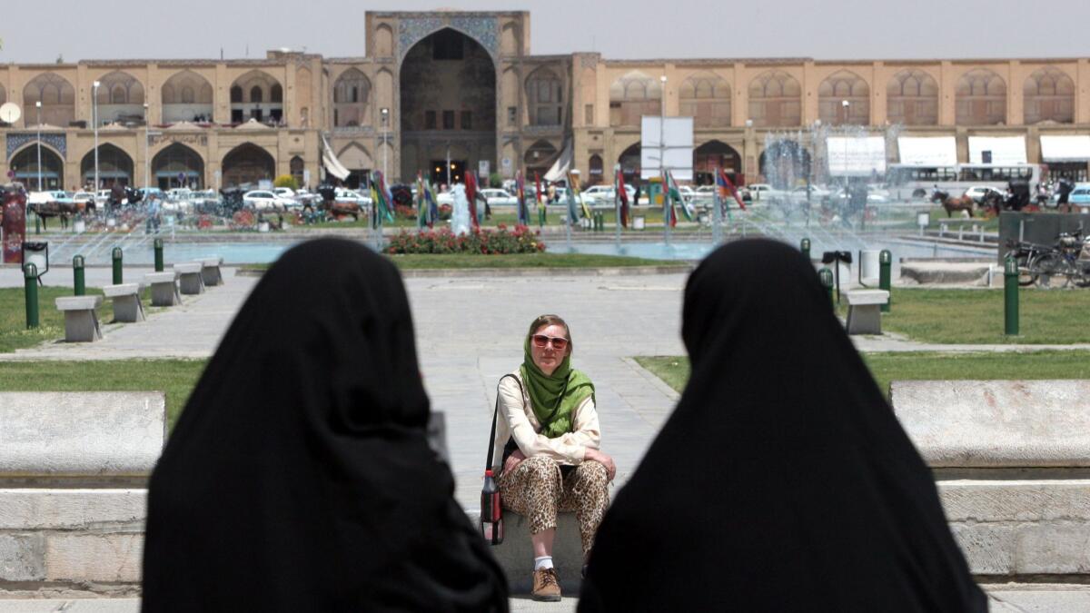 A visitor rests in Esfahan in 2006. A recent shift from Western tourism pleases Iran’s hard-liners, who they say they don’t want the “cultural invasion” anyway. But experts say sanctions have slowed development of the nation’s tourism industry.