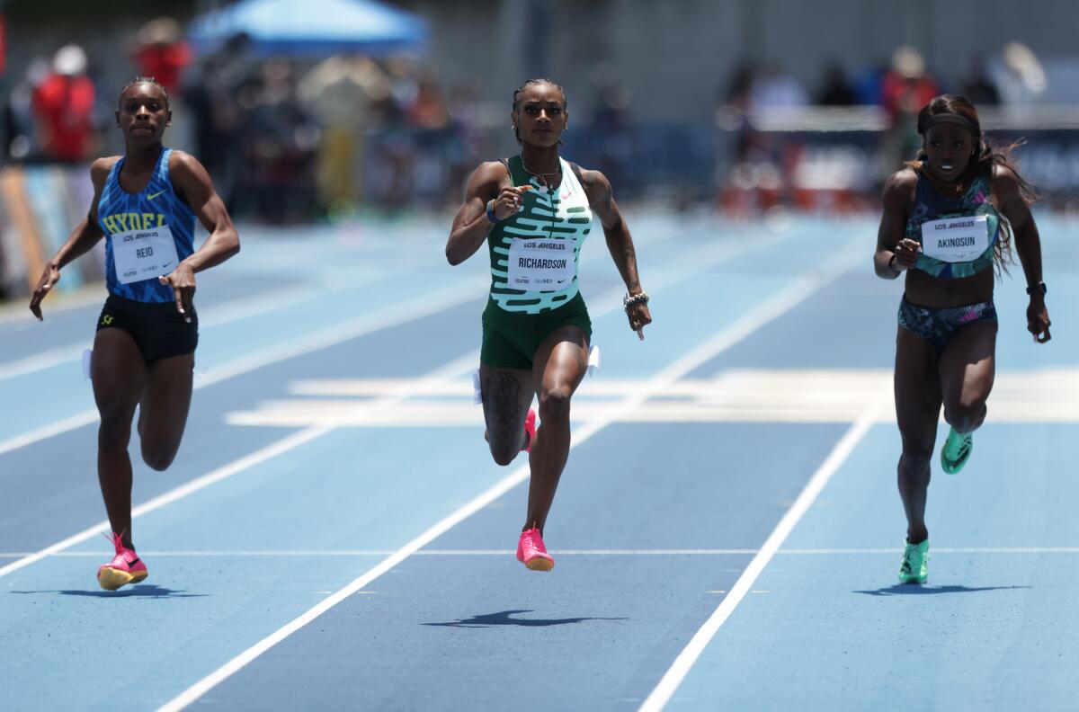 Sha'Carri Richardson, center, competes in a 100-meter qualifying heat Saturday during the Los Angeles Grand Prix.