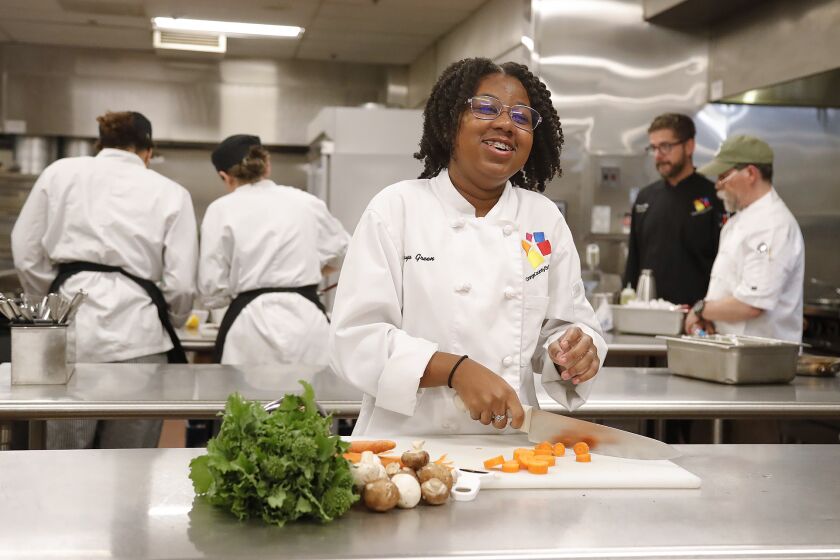 Anaya Defour, a freshman in the Culinary Arts Academy, works at her station at the Orange County School of the Arts kitchen in Santa Ana on Friday.