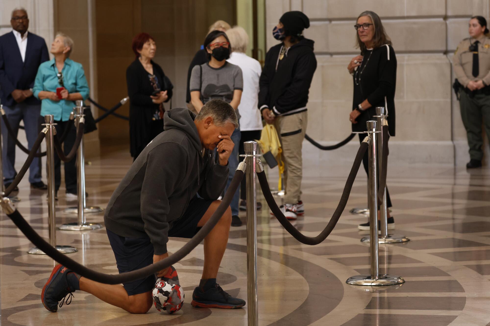 A man kneels in remembrance of the late U. S. Senator Dianne Feinstein