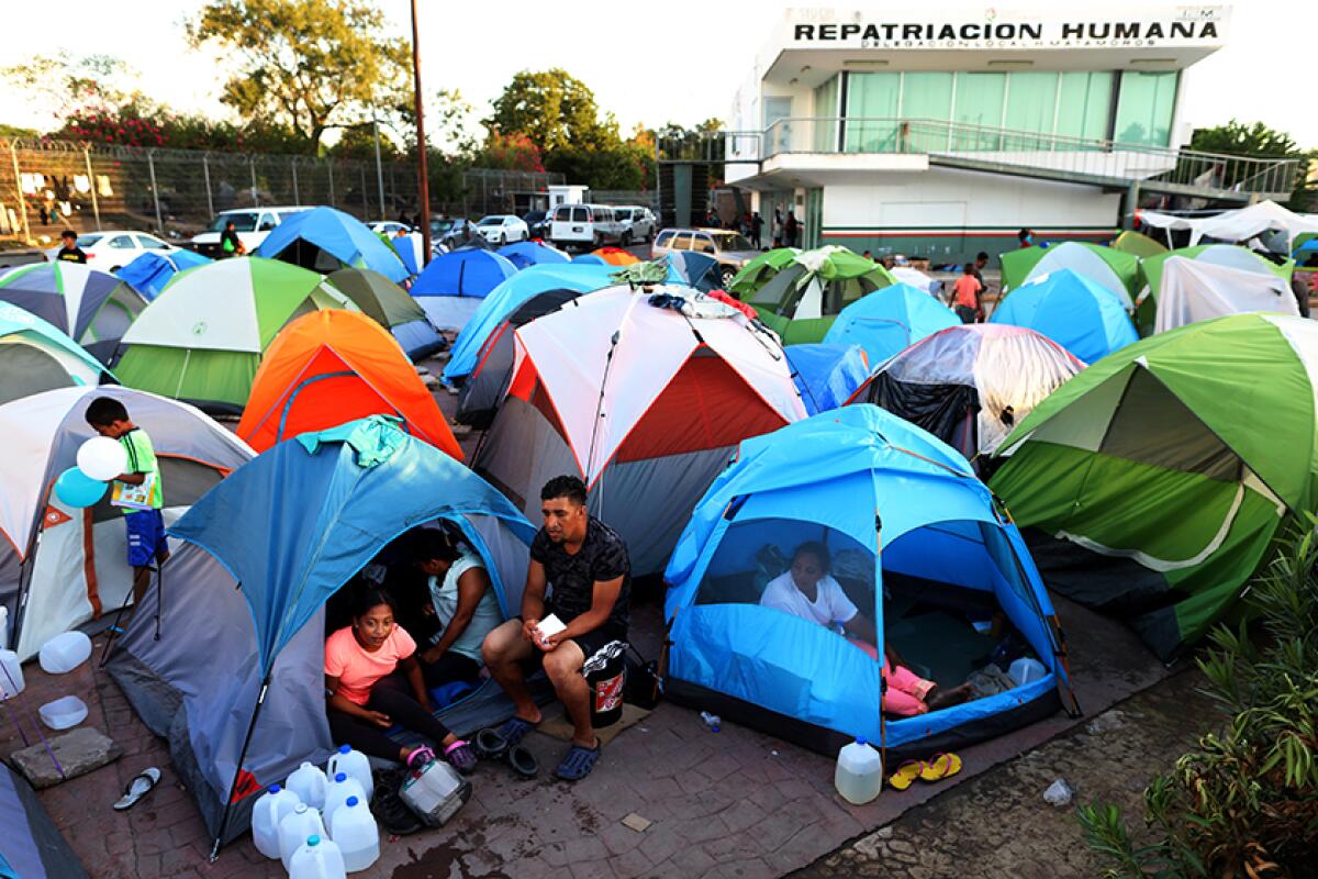 Several tents crowded in an encampment in Mexico near the U.S. border.
