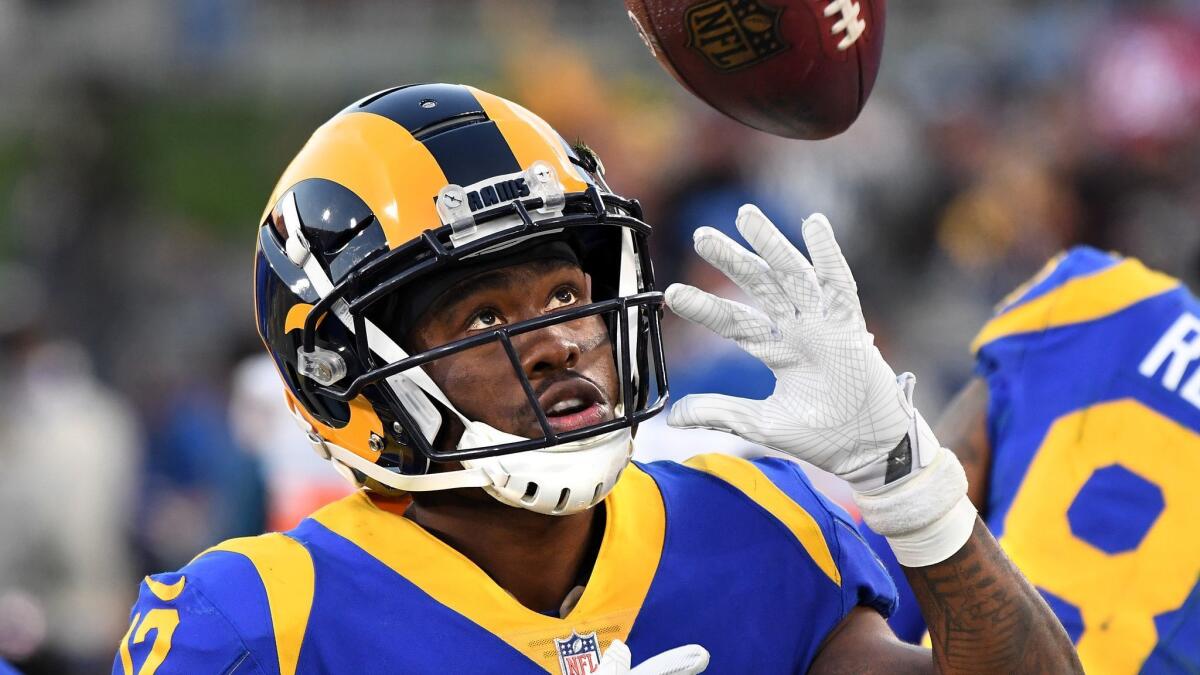 Rams receiver Brandin Cooks plays with a football on the sidelines during a game against the 49ers at the Coliseum on Dec. 30, 2018.