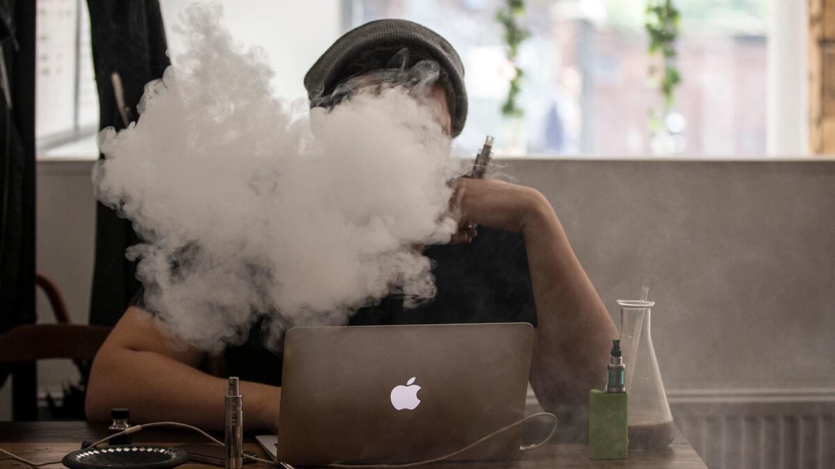 A student uses a vaping device.