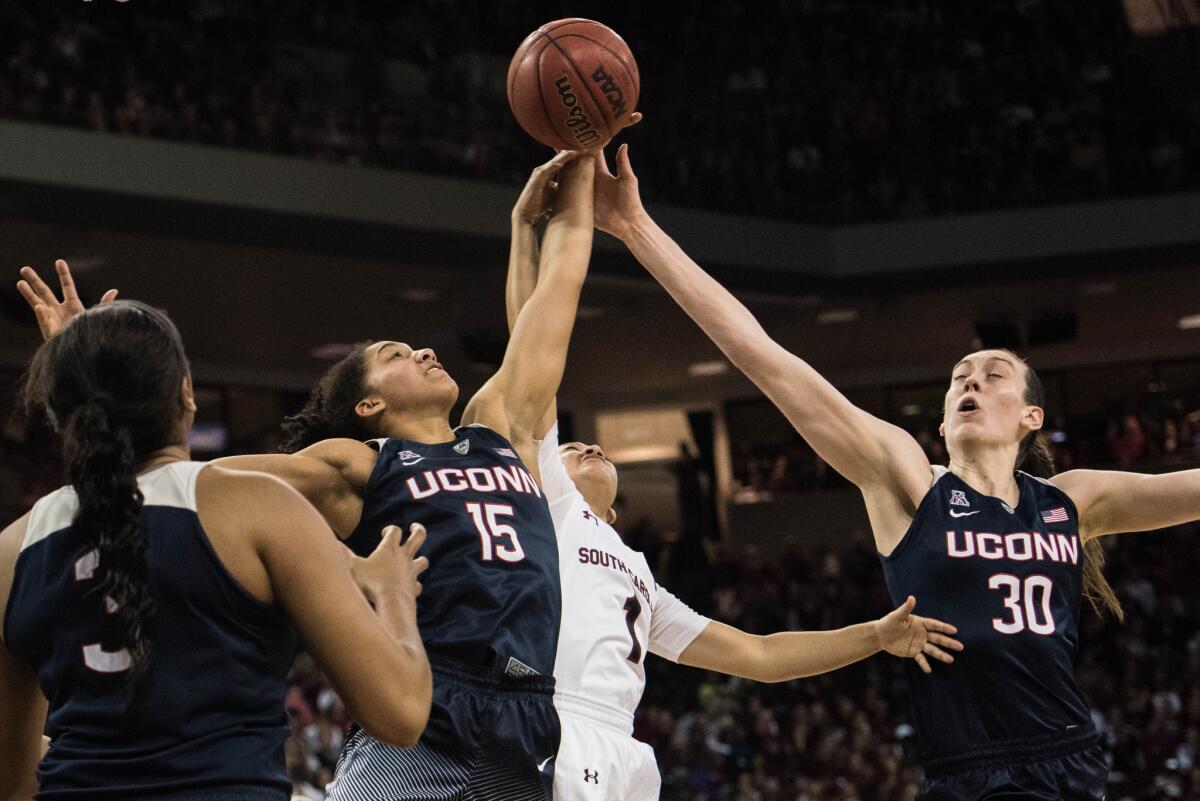 Connecticut forward Breanna Stewart (30) and teammate Gabby Williams (15) battle South Carolina guard Bianca Cuevas (1) for the ball during the second half.