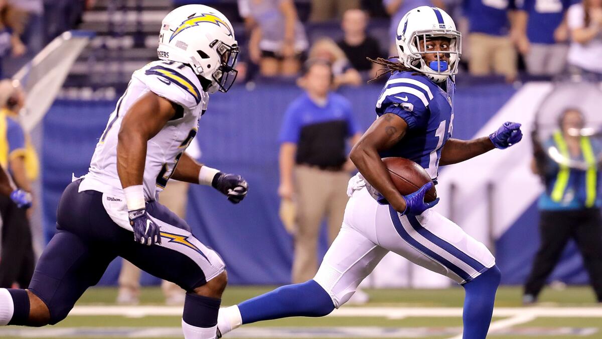 Colts receiver T.Y. Hilton glances back at Chargers defensive back Adrian Phillips as he breaks away for a 63-yard touchdown pass play in the fourth quarter Sunday.