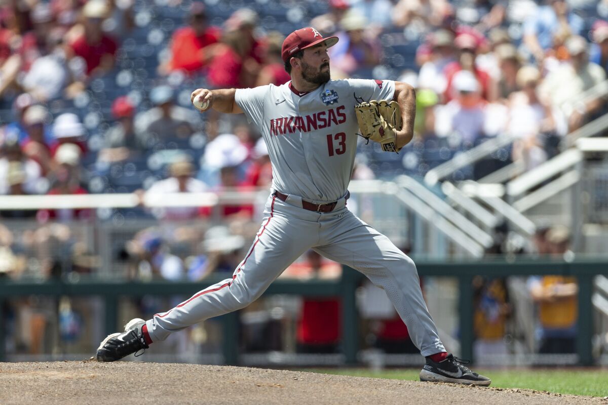 Arkansas starting pitcher Connor Noland (13) throws a pitch against Stanford in the first inning during an NCAA College World Series baseball game Saturday, June 18, 2022, in Omaha, Neb. (AP Photo/John Peterson)