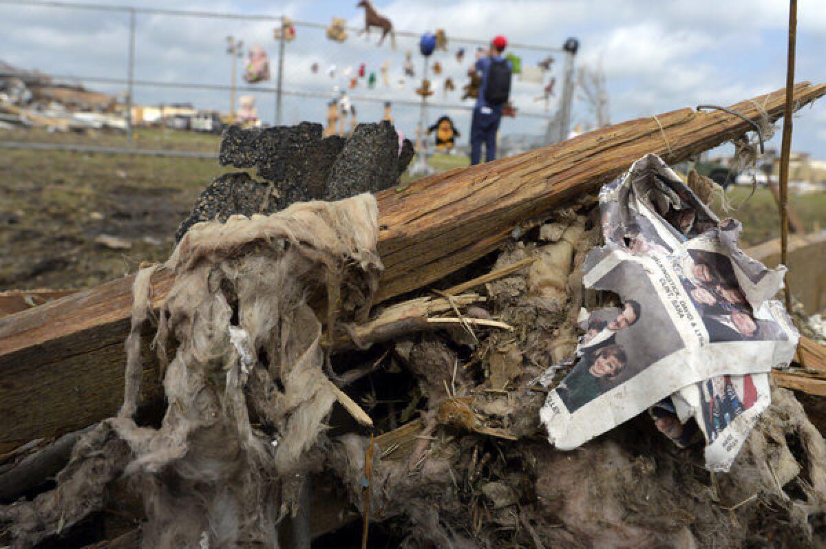A picture book is seen in debris near a makeshift memorial on the grounds of the Plaza Towers elementary school in Moore, Okla.