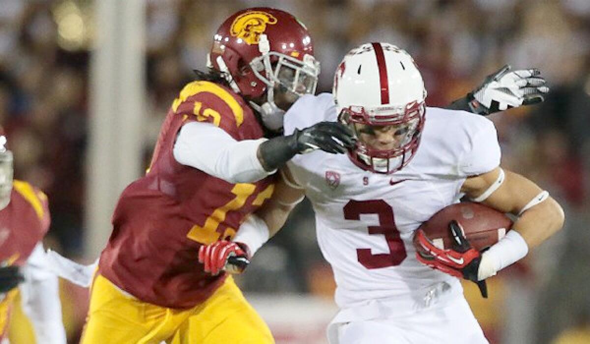 USC cornerback Kevon Seymour tackles Stanford wide receiver Michael Rector during a game on Nov. 13.