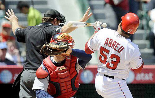 Angels right fielder Bobby Abreu ducks away from an inside pitch by Josh Beckett after umpire Paul Schreiber had called time during the first inning Sunday. Abreu and Beckett had words, causing a benches-clearing incident.