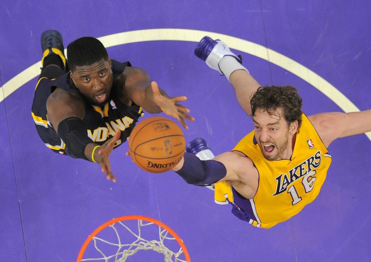 Lakers power forward Pau Gasol and Pacers center Roy Hibbert battle for a rebound during Tuesday's game at Staples Center.