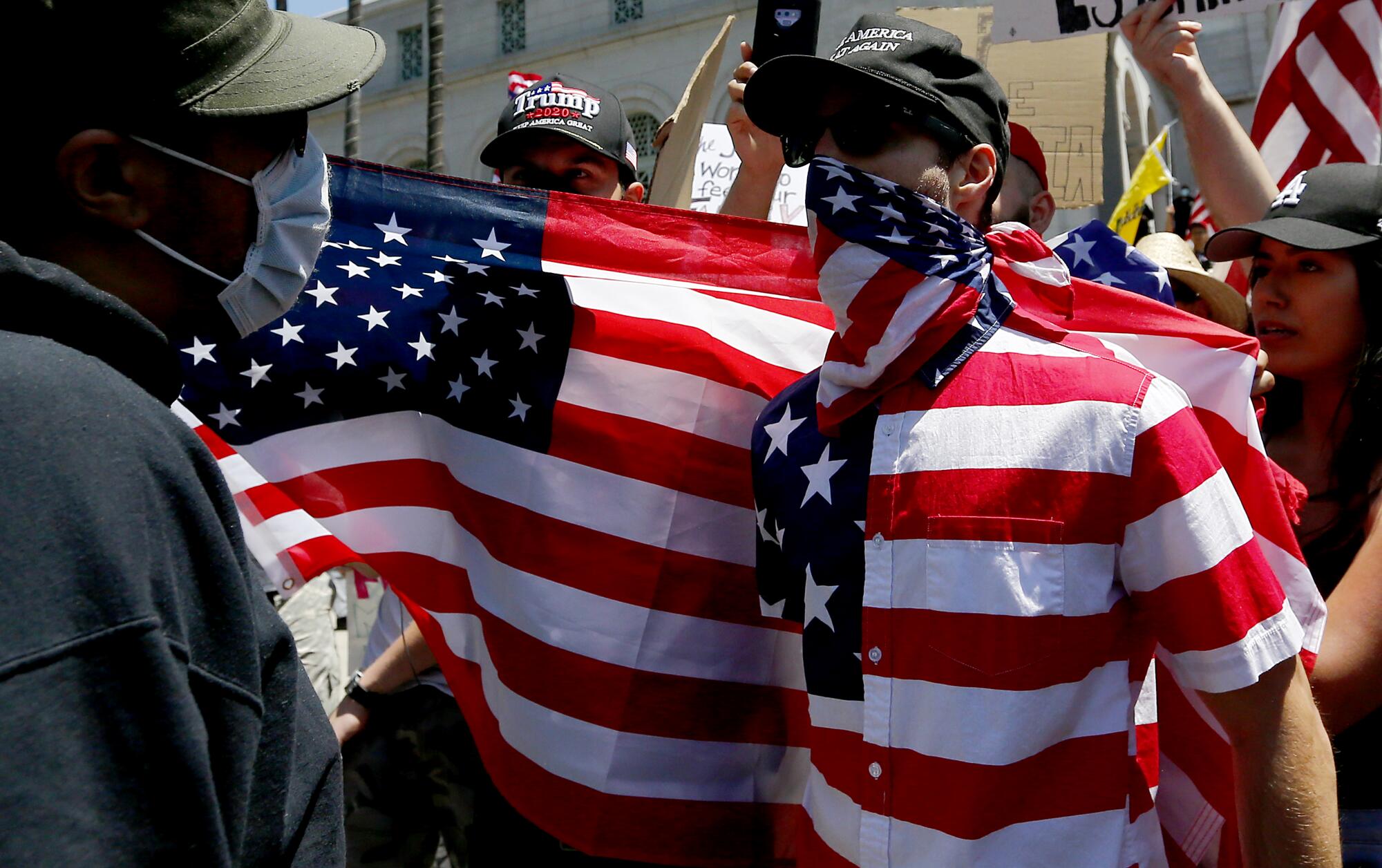  A supporter of President Trump, right, gets into a verbal altercation with a counterdemonstrator at L.A. City Hall