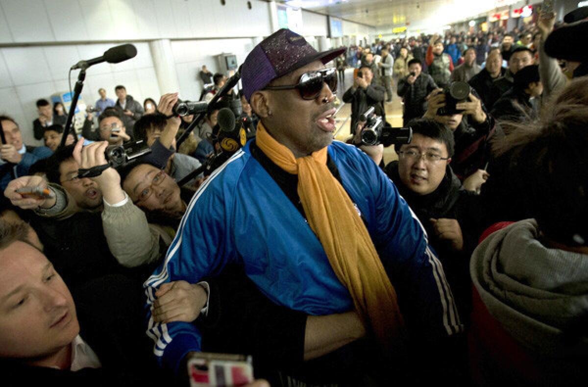 Former NBA star Dennis Rodman is surrounded by members of the media as he arrives Monday at the Capital International Airport in Beijing after visiting North Korea last week.