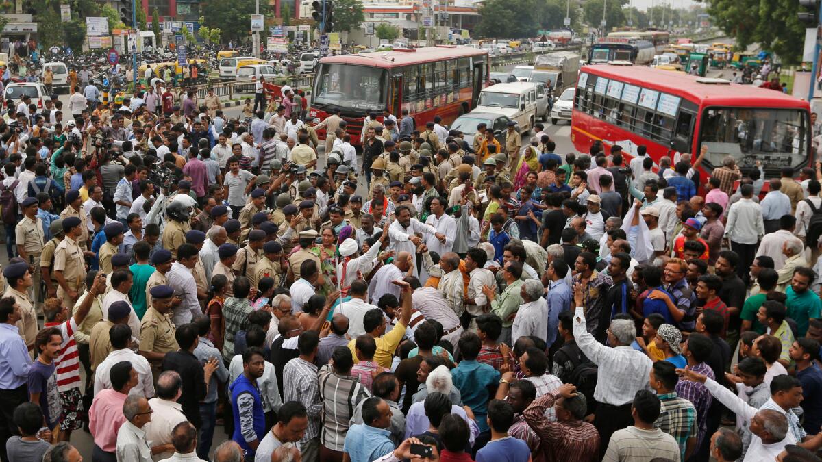 Protesters denounce the beating of four Dalit men who were attacked while skinning a dead cow in India.