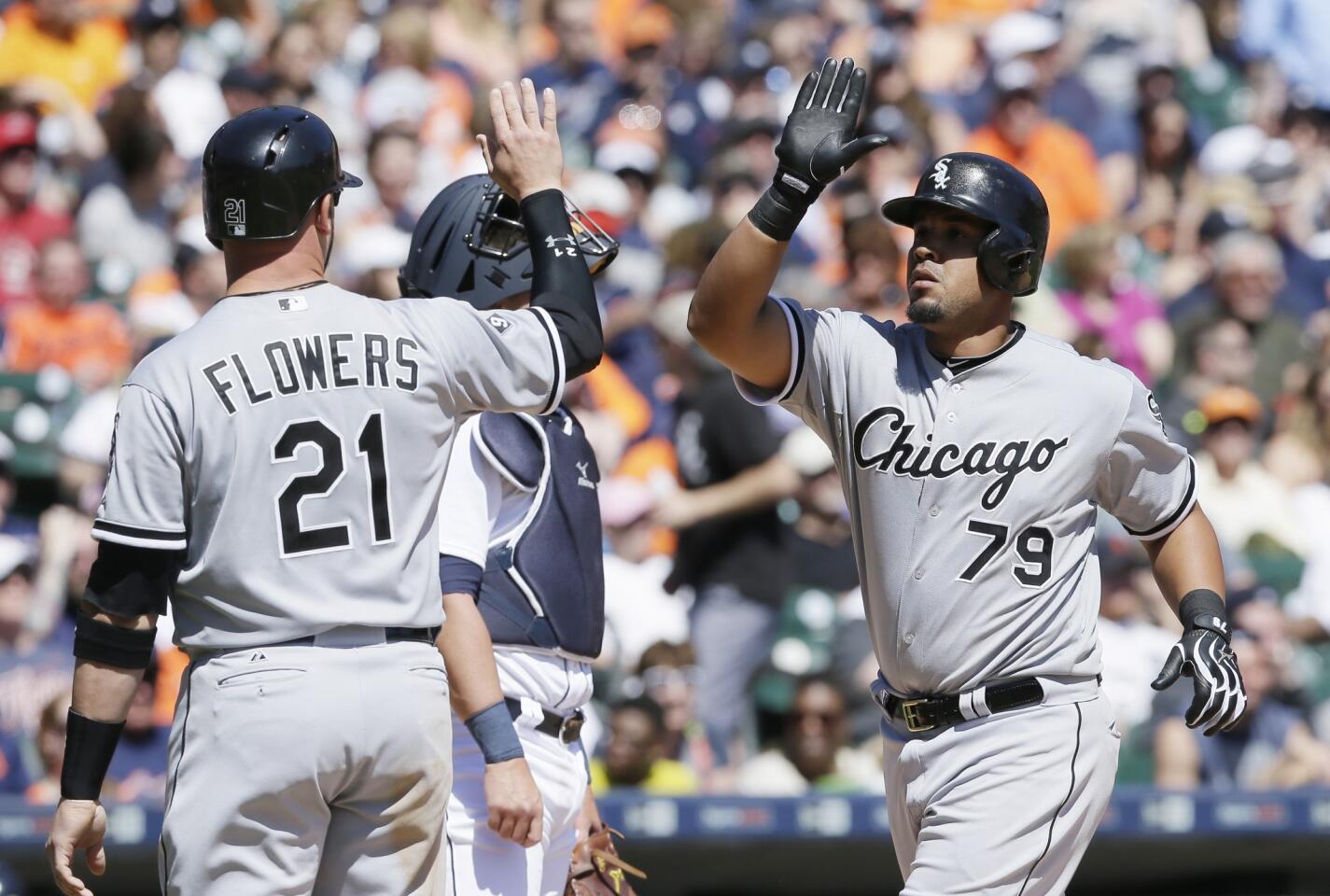 Jose Abreu greets Tyler Flowers after Abreu's grand slam during the fourth inning.