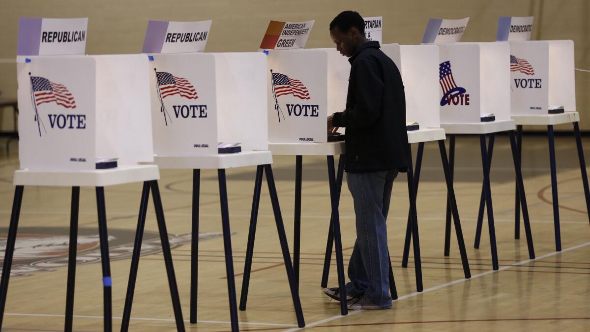 Thando Mlauzi is among the first to vote at Van Nuys High School on Tuesday morning.