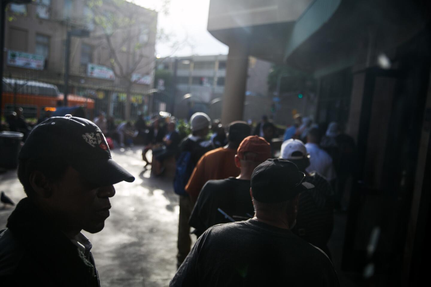 Homeless men line up outside the Los Angeles Mission seeking shelter. Charly Leundeu Keunang's death underscored how skid row remains a minefield for police and homeless people.